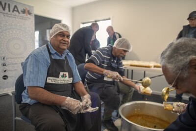 Members of the Waitakere Indian Association cook and pack meals for distribution