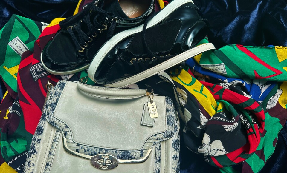 A handbag, sneakers, and a colourful scarf arranged in a display