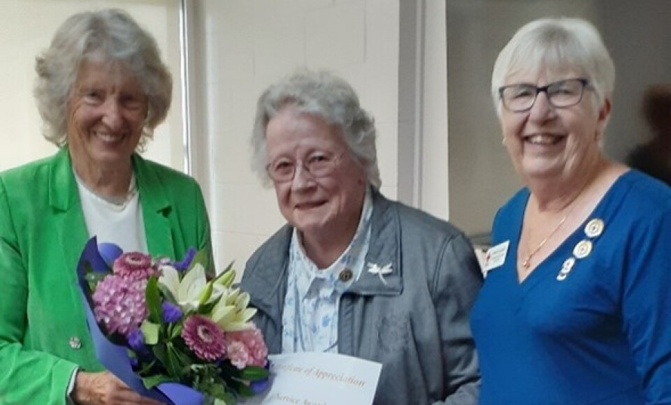 Three older women standing together