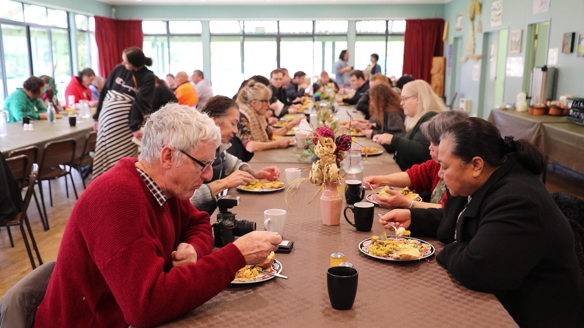 People enjoying food at a Marae