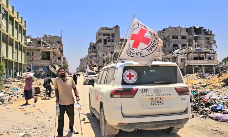 A man using crutches next to an ICRC vehicle