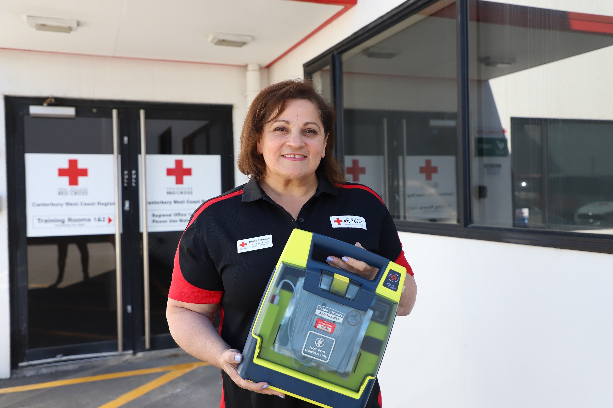 A Red Cross volunteer holds a first aid kit