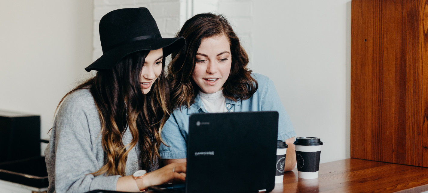 Two women looking at a laptop together
